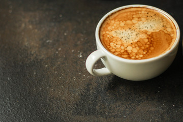 Obraz na płótnie Canvas coffee freshly brewed in a white cup serving of beverage (coffee grain). food. top. copy space