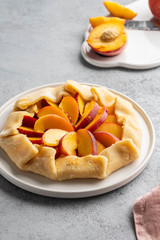 Appetite summer peach galeta on white table with copy space. summer open tart photo for cook book or food blog.