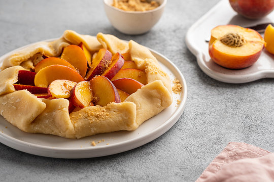 Appetite summer peach galeta on white table with copy space. summer open tart photo for cook book or food blog.