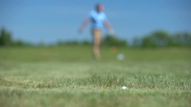 Silhouette of male golf player losing ball, upset with bad shot result at course