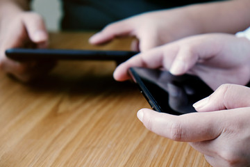 Friends watching social media in a smart phone. social network concept with smart phone. white screen for mockup.