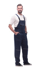 side view. smiling man in overalls looking forward to copy space