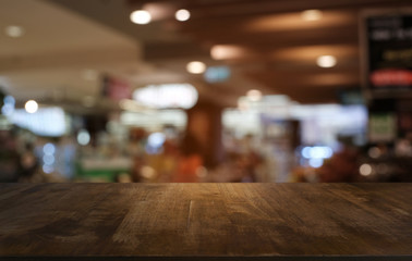 Empty dark wooden table in front of abstract blurred bokeh background of restaurant . can be used for display or montage your products.Mock up for space.