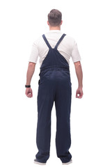 rear view. young man in overalls looking forward