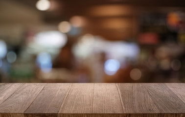 Empty dark wooden table in front of abstract blurred bokeh background of restaurant . can be used for display or montage your products.Mock up for space.