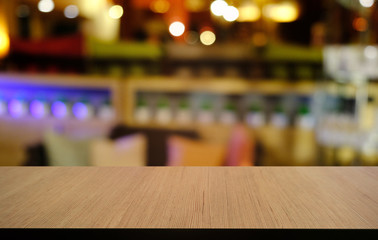 Empty dark wooden table in front of abstract blurred bokeh background of restaurant . can be used for display or montage your products.Mock up for space.