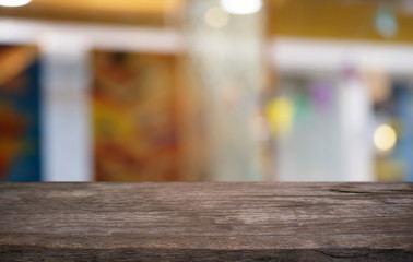 Naklejka na ściany i meble Empty dark wooden table in front of abstract blurred bokeh background of restaurant . can be used for display or montage your products.Mock up for space.