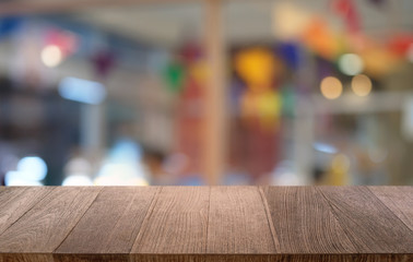 Empty dark wooden table in front of abstract blurred bokeh background of restaurant . can be used for display or montage your products.Mock up for space.