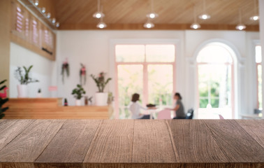 Empty dark wooden table in front of abstract blurred bokeh background of restaurant . can be used for display or montage your products.Mock up for space.