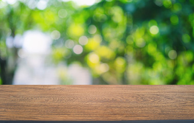 Empty dark wooden table in front of abstract blurred bokeh background of restaurant . can be used for display or montage your products.Mock up for space.
