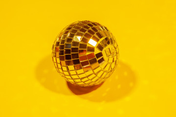 Shiny party disco balls shining in a day light over color background