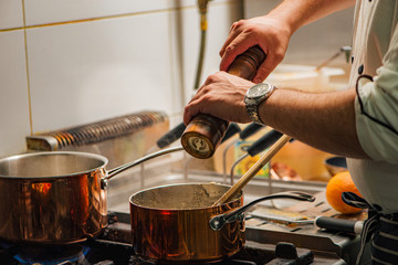 Professional chef cooking meal on a stove in a restaurant.