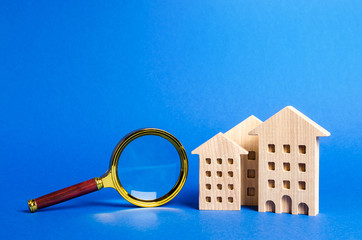 figures of house apartments buildings and magnifying glass. Home appraisal. Property valuation....