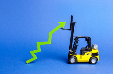 A yellow forklift raises a big green arrow up. Growth in production rates and development of industry and infrastructure. Increased sales, economy growth. Concept of increase, growth and success.