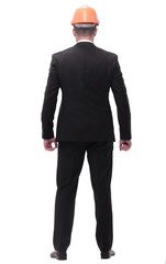 rear view. confident businessman in orange protective helmet