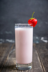 Strawberry milkshake with on the rustic background. Selective focus. 