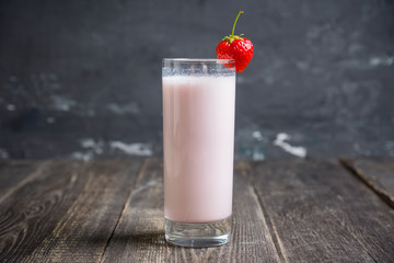 Strawberry milkshake with on the rustic background. Selective focus. 