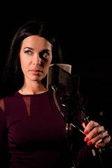 Young woman singer in front of microphone.