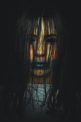 Scary witch with black eyes on dark background