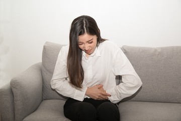 Asian woman having painful stomachache,Female suffering from abdominal pain..