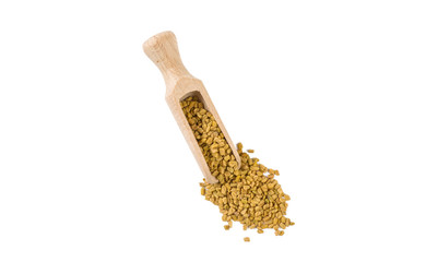 fenugreek seeds in wooden scoop isolated on white background. top view. spices and food ingredients.