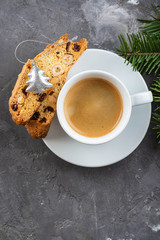 Traditional Christmas pastries, Italian homemade double-baked biscotti or cantuccini cakewith coffee, with nuts and dried fruits. with xmas decorations and fir branches.