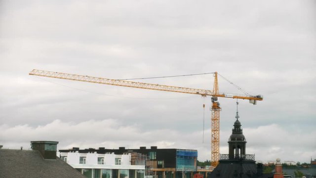Time lapse of construction crane and Swedish city skyline, line of business in building industry on the rise and economy flourishing in Sweden