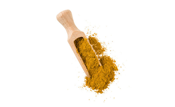 Yellow Curry In Wooden Scoop Isolated On White Background. Top View. Spices And Food Ingredients.