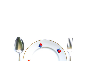 served table for meals. Fork, spoon and plate - simple breakfast, lunch or dinner.