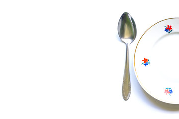 designer fragments of the served table for eating. Fork, spoon and plate - simple breakfast, lunch or dinner.