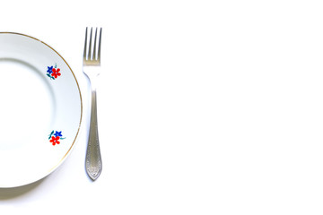 designer fragments of the served table for eating. Fork, spoon and plate - simple breakfast, lunch or dinner.