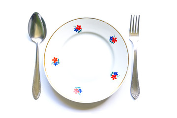served table for meals. Fork, spoon and plate - simple breakfast, lunch or dinner.