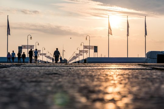 People Walking On The Sopot Pier During A Charming Sunrise