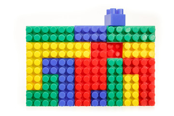 Children's colorful plastic construction toy bricks on white