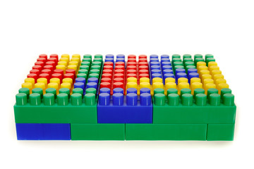 Children's colorful plastic construction toy bricks on white