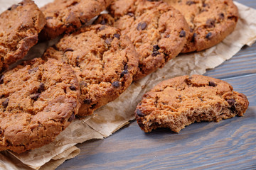 Chocolate oatmeal chip cookies on the rustic wooden table.