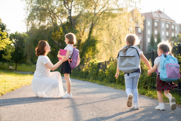 Fototapeta premium Parent and pupils are going to school