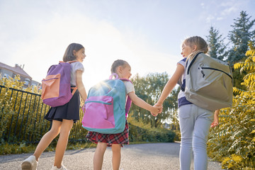 Girls with backpack are going to school
