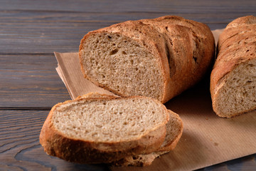 Bread and slices on wooden table