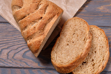 Bread with bran, sliced on an wooden table, selective focus. Homemade bread
