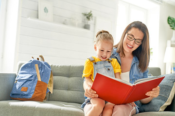 mother and daughter are reading a book.