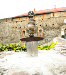 Sword in the stone near the castle. Saint Arthur's style medieval period. Middle ages photo. Old walls and weapon. Ancient history in details.