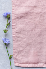 blue flower on linen tablecloth, minimalism