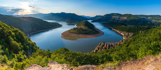 Bulgaria, Kardzhali dam, view of meander in Arda river, surrounded with green forest, summer time during sunset - obrazy, fototapety, plakaty
