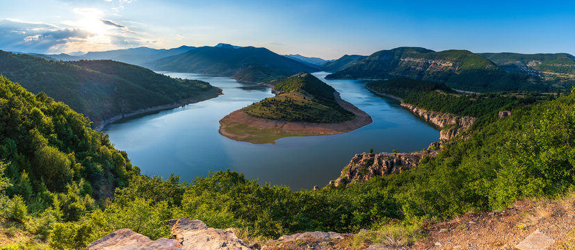 Bulgaria, Kardzhali dam, view of meander in Arda river, surrounded with green forest, summer time during sunset