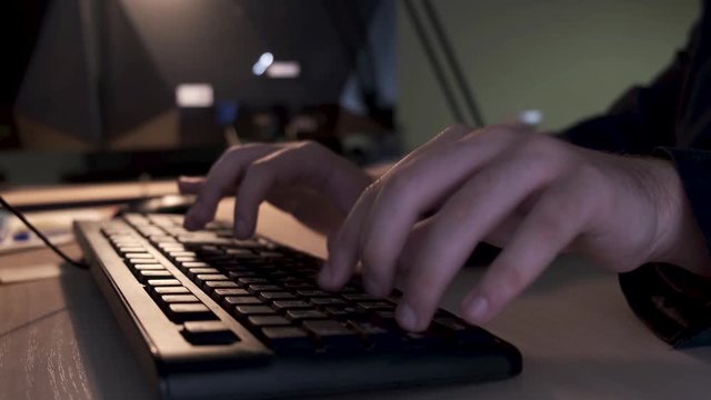 Close up of businessman hands typing on computer keyboard lying on a wooden table in the office, management concept. Stock footage. Male fingers typing message on the keyboard.