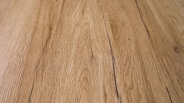 Slow mo of the beautiful finished wood floor with contemporary style and finest clear natural colors of the red oak hard wood boards. Flooring has distinctive brown grain patterns and wood age lines
