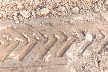 Tyre track on dirt sand or mud, Picture in retro or grunge tone. The road track. Tractor wheel tracks.