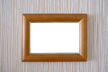 wooden frame on the wall with a white background in the middle. Wall with wallpaper and photo frame in the center.