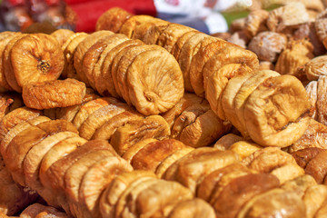 A lot of figs on the market stall, dried fruits closeup, texture and background